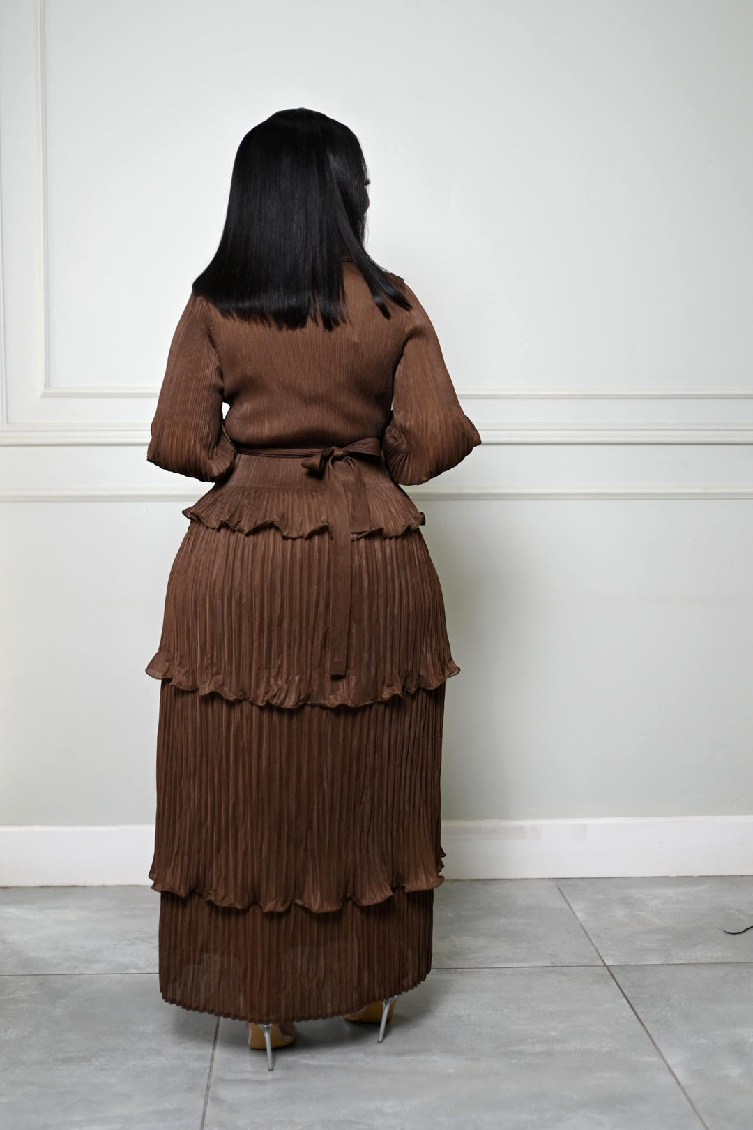 The Plissé Column Dress in brown, back view with belt